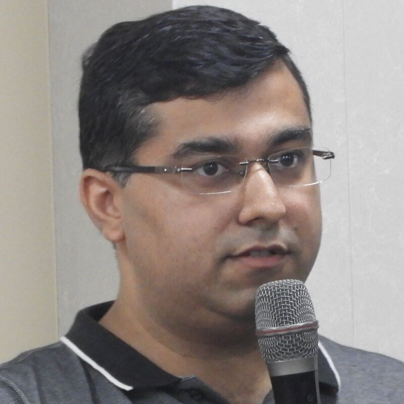 Close view of Dipender Bhamrah speaking into a microphone during a guest lecture